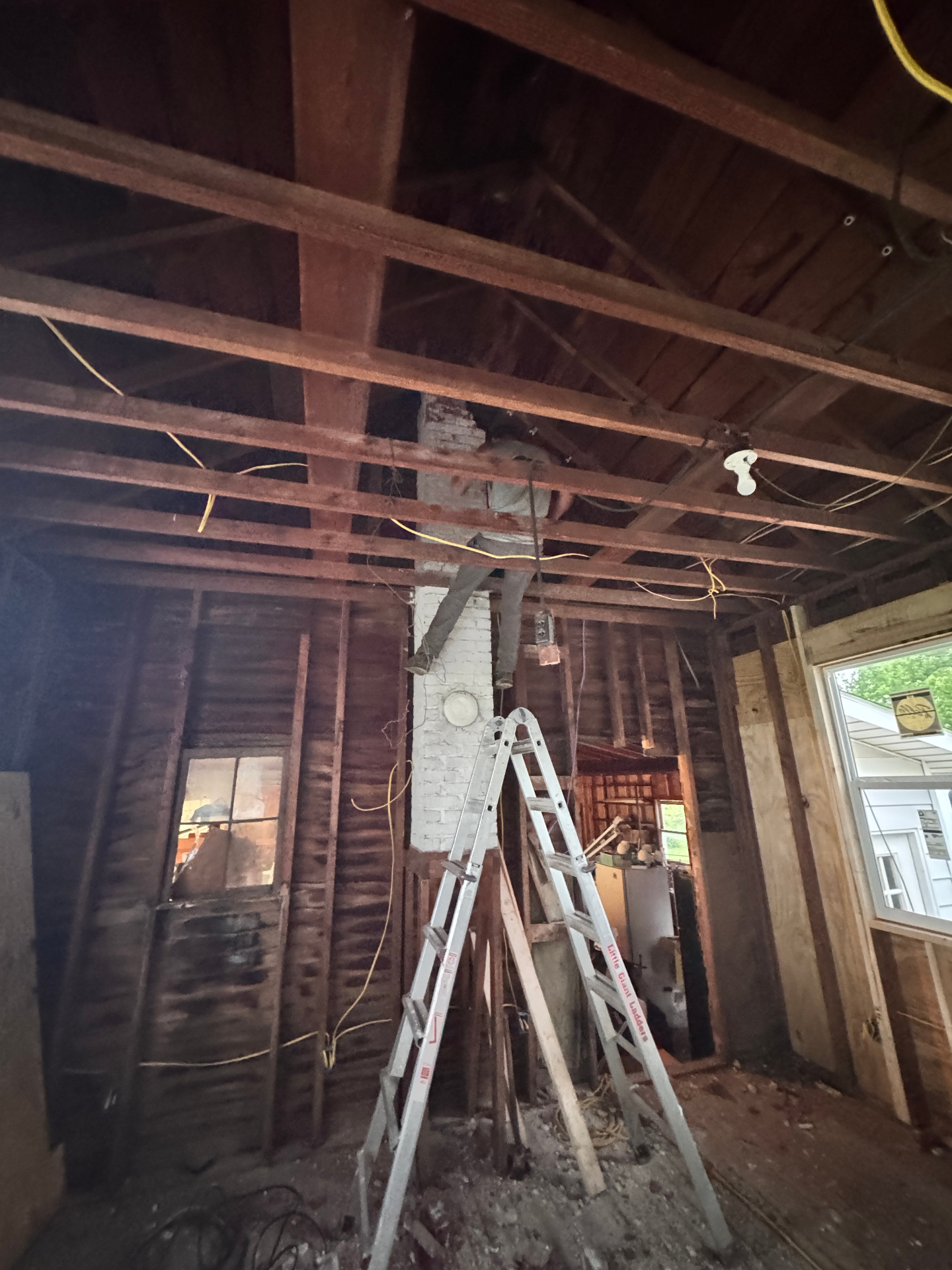Interior of structure mid-demolition with exposed framing