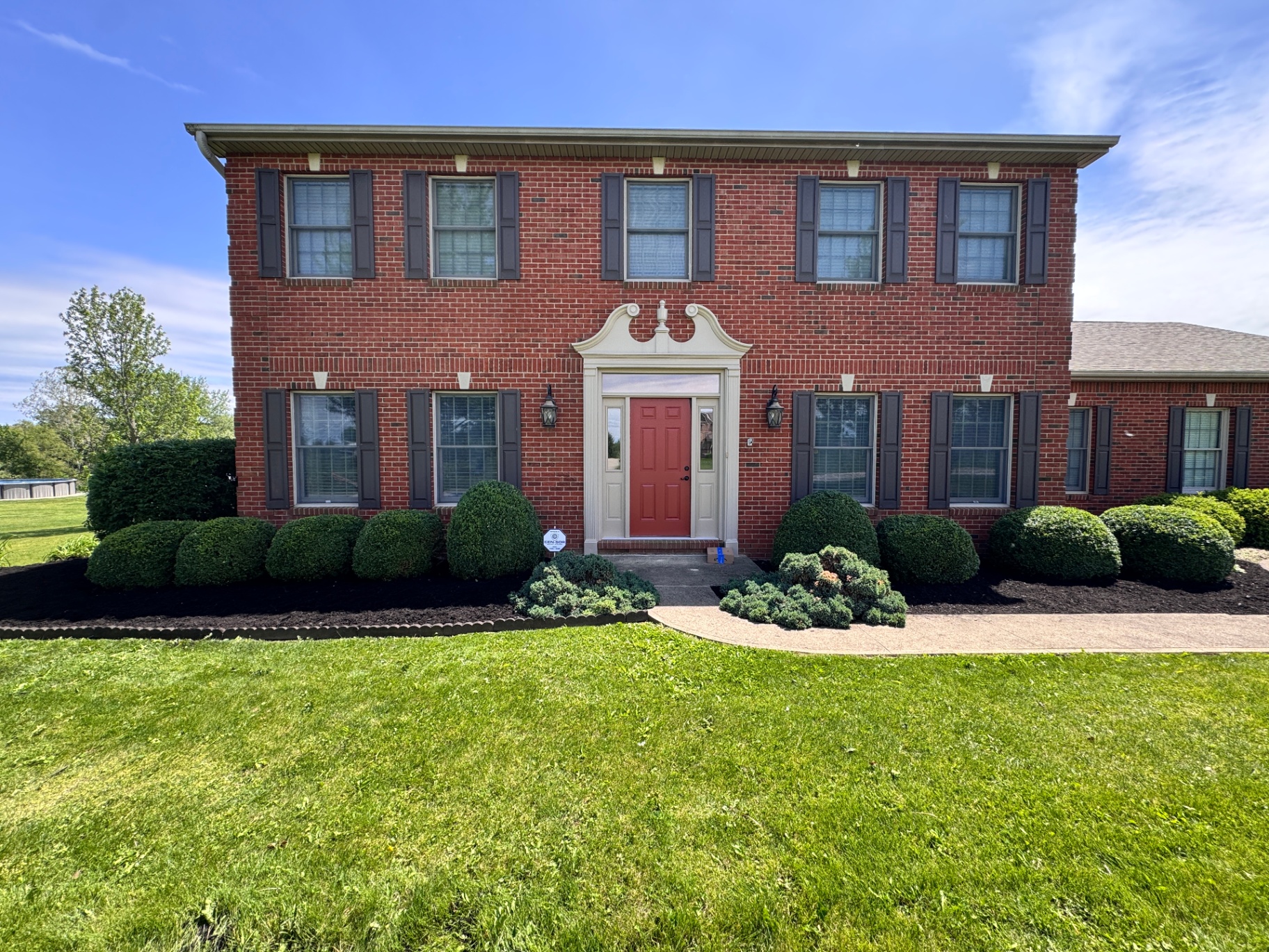 Front entry mulch bed with trimmed shrubs
