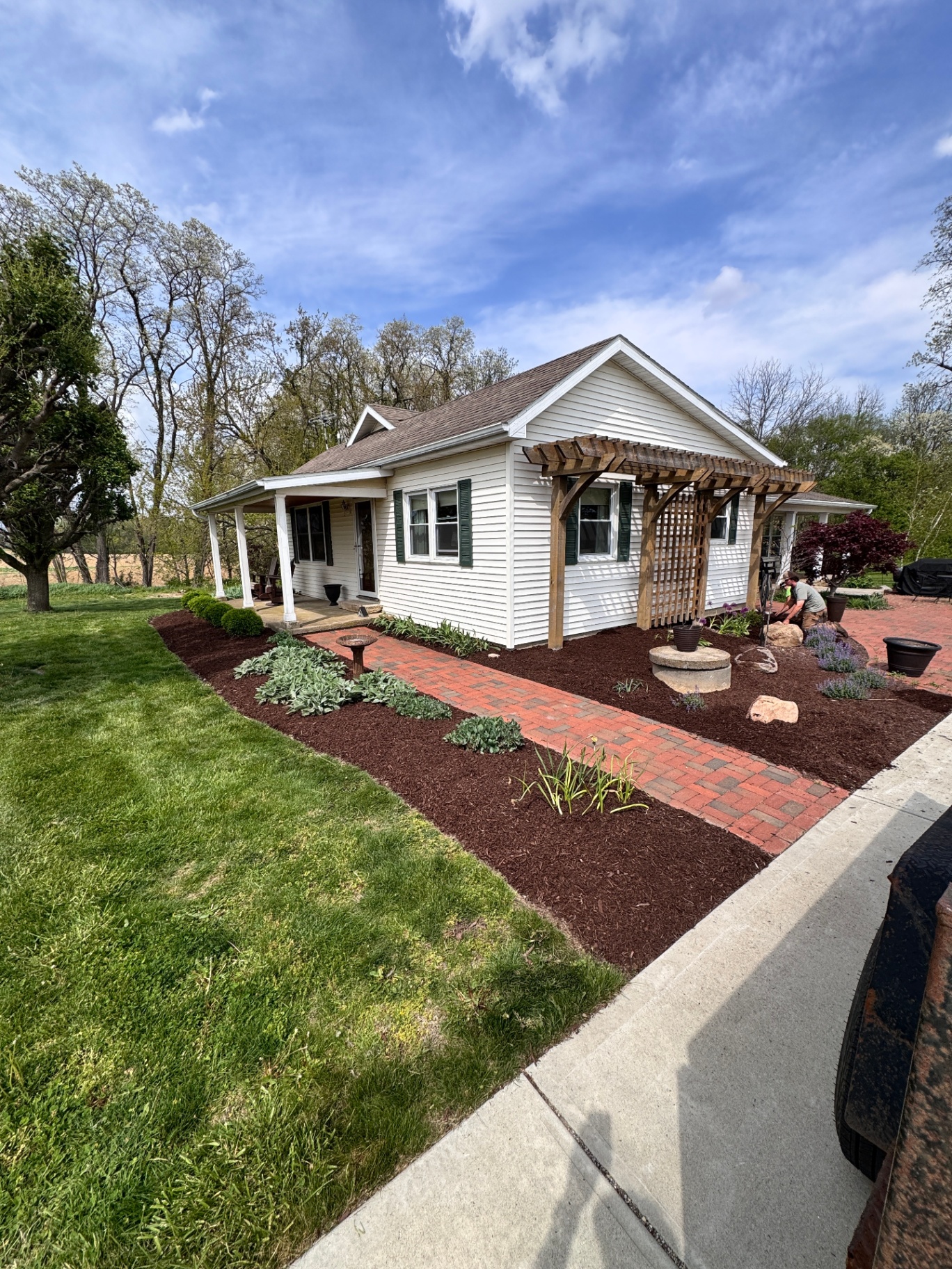 Brown mulch beds around a pergola