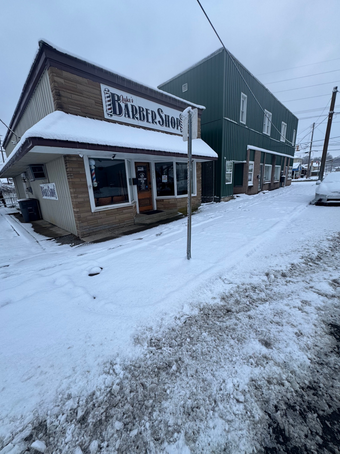 Snowy commercial storefront before clearing