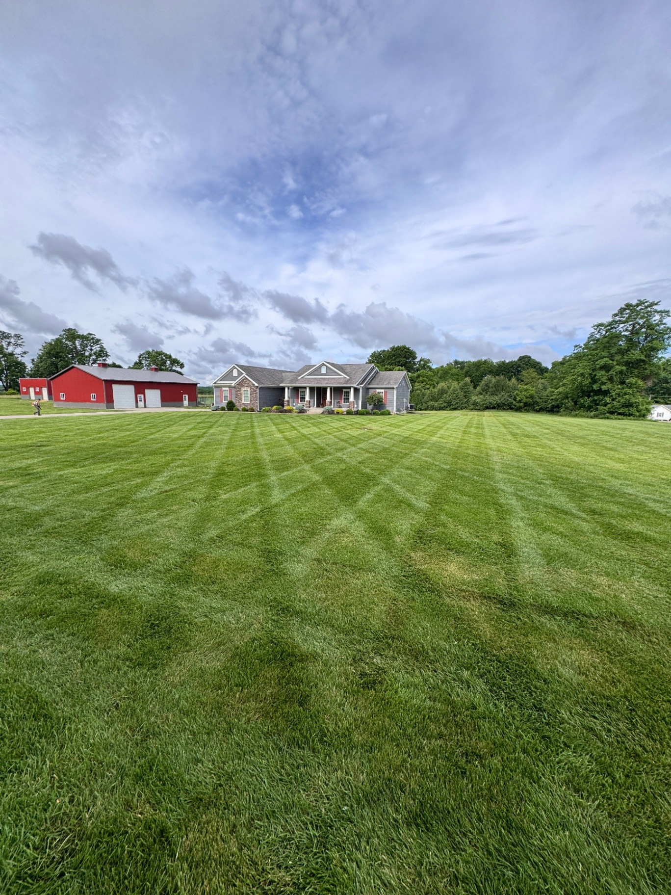 Freshly mowed lawn in front of home and barn